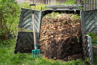 A commercially available single chamber compost bin is shown with finished compost at the bottom.