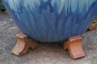 Allow for good drainage by setting the container on pot feet.