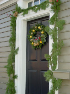 A pine garland frames a doorway and has long-lasting needle retention.