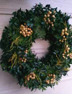 Boxwood wreaths are long lasting, and may be decorated with white nandina berries and gold mop cypress for interesting accents.