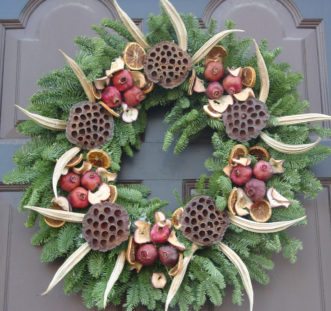 Okra pods provide an interesting accent to the dried fruit, lotus seed pods and Fraiser fir wreath.