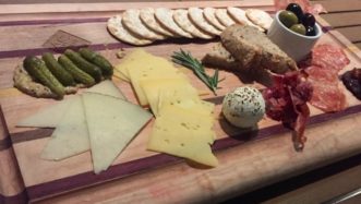 A Charcuterie board with an assortment of foods carefully paired and styled up.
