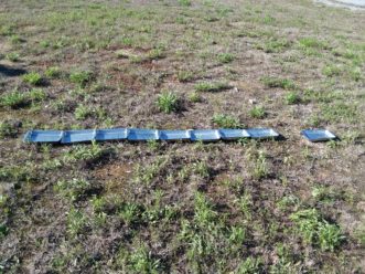 Pans labeled 0-9 placed in a straight line. A space is left between the “0” and “2” pans for the spreader wheel to pass through. Justin Ballew, ©2018, Clemson University
