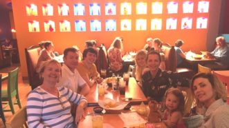 Family sitting down together to enjoy a family meal.