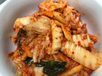 Kimchi is a traditional Korean dish prepared by fermenting cabbage and spices. 