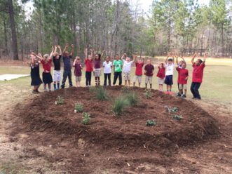 During the rain garden workshop with educators from the Midlands, the environmental club students from Lower Lake Carolina Elementary School finished this rain garden by adding mulch.