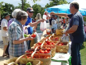 “Shoppers purchase locally grown tomatoes at the City of Clemson Farmer’s Market in Clemson, SC”. 