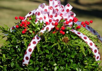 Additional decorative touches add a festive air to the kissing ball.