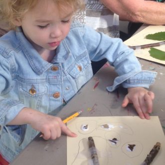 Garden Sprout making art with sticks.