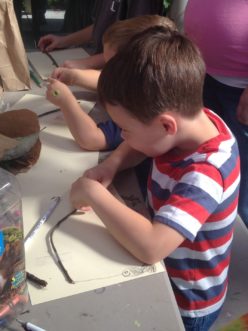 Garden Sprout making art with sticks.