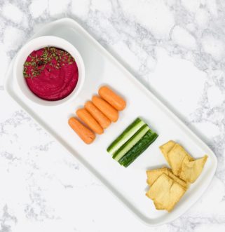Roasted beet hummus paired with vegetables and crackers.