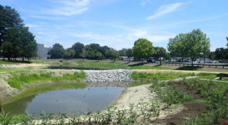 Once this recently-constructed forebay fills with water, it flows over the rip-rap spillway into the main pond. The forebay, located at Charleston County’s Public Services Building, was installed as a pre-treatment trap for sediment, and associated pollutants, helping protect the main basin of the pond. Photo courtesy Chuck Jarman.
