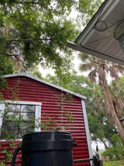 “A rain barrel receives water flowing off of a roof during a rain event; water is directed towards rain barrel using a gutter.” 
