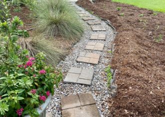 An impervious, concrete sidewalk was removed and replaced with gravel and stepping stones to allow rainwater to soak into the ground. Kim Morganello, ©2020, Clemson Extension