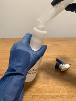 Making a labeled spray bottle of dilute sanitizer.