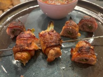 Serve bacon wrapped quail breast with sauce.