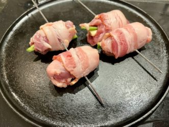 Quail breast stuffed with peppers, cheese and wrapped with bacon.