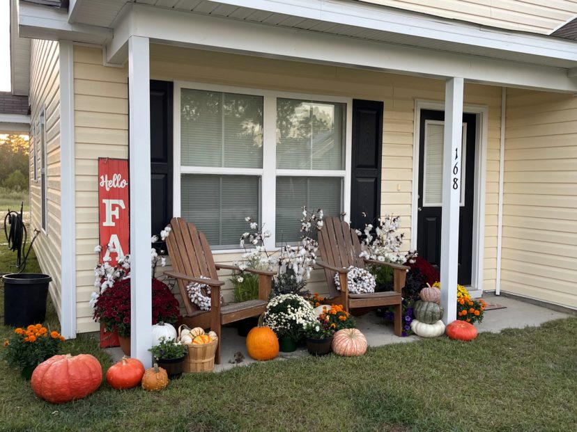 Dressing up the porch with fall flowers and gourds can add a nice touch to the start of the holidays.