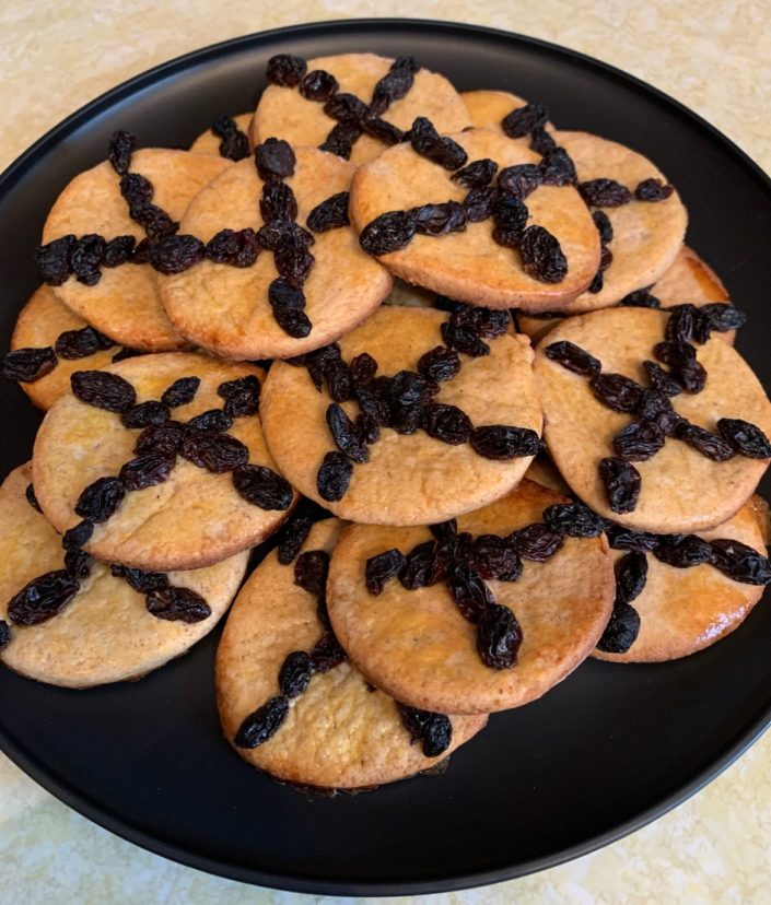 Soul cakes are small baked cakes similar to scones, mixed with warming spices and decorated with a cross made of dried fruit or cut into the cake.