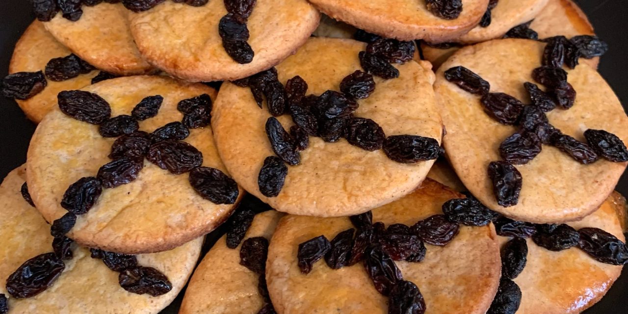 Soul cakes are small baked cakes similar to scones, mixed with warming spices and decorated with a cross made of dried fruit or cut into the cake.