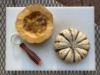 A pumpkin scoop or spoon is efficient for removing seeds.