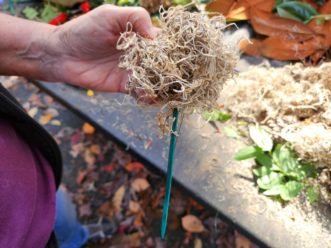 After pushing the floral pick through the ball, wrap the stem wire pieces securely around it.