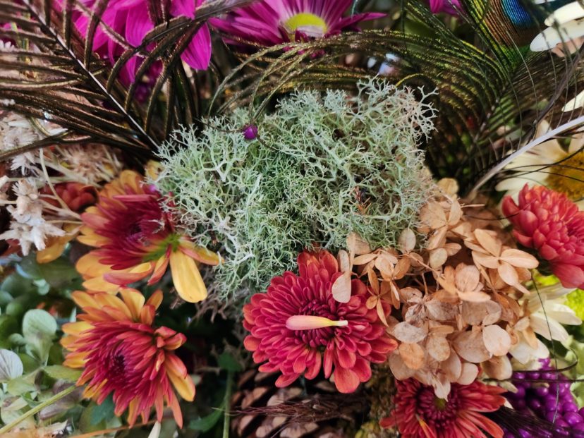 Reindeer lichen adds a textural element and a contrasting silver color to the flowers.