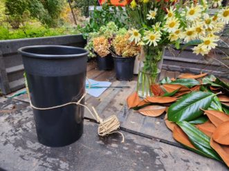 Wrap the raffia floral wire around the middle of the container.