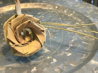 Rosettes fashioned from palmetto fonds add textural interest to the Christmas tree.