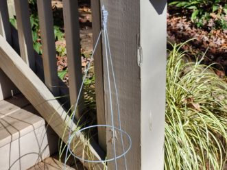 The tomato cage with taped wires will create the frame for the gnome’s body.