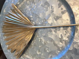 Trim the leaves on a palmetto frond to create a fan and spray with gold paint for a splash of gilded color.