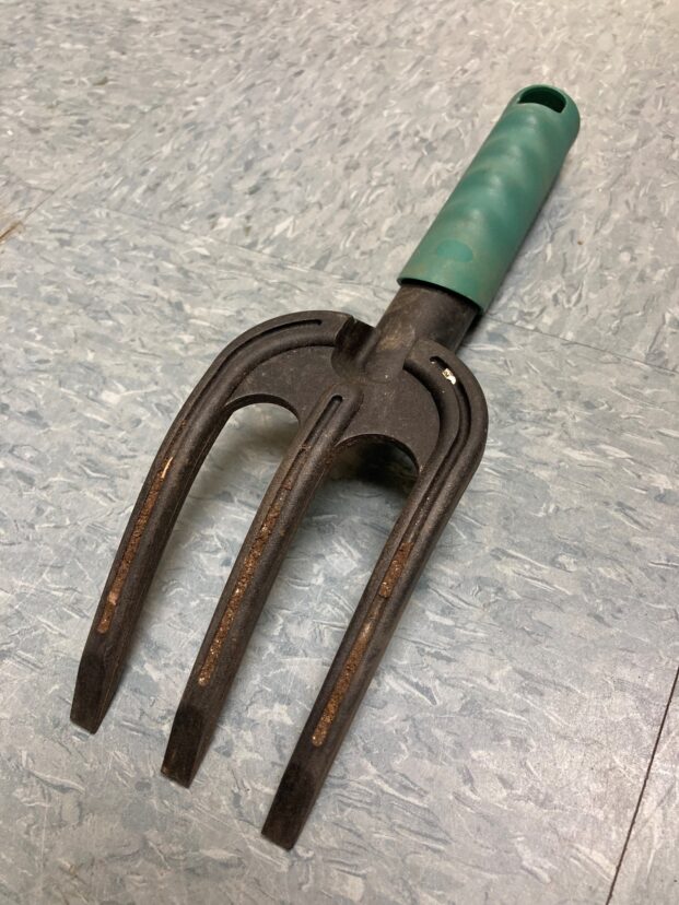 Some tools, like this garden fork, have grooves that hold soil.