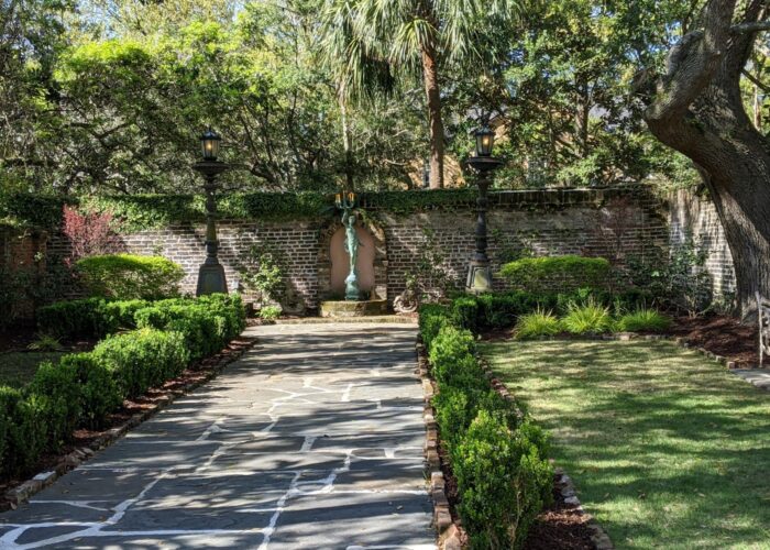boxwood-line-a-pathway-in-this-courtyard-garden- Boxwood line a pathway in this courtyard garden.