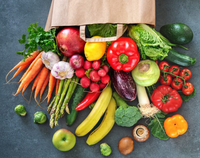 Shopping bag full of fresh vegetables and fruits.