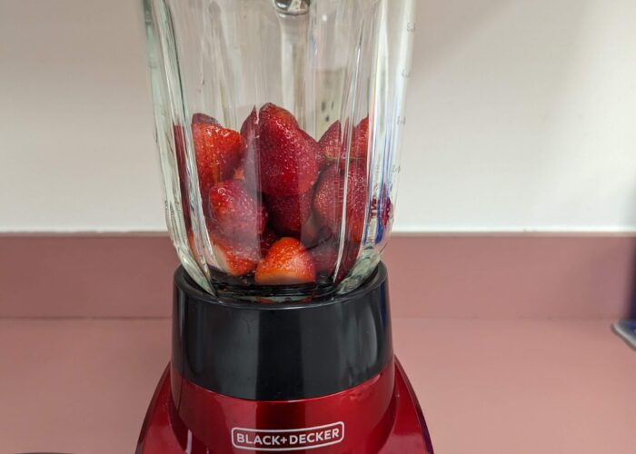 Whole strawberries in the blender pitcher before blending.