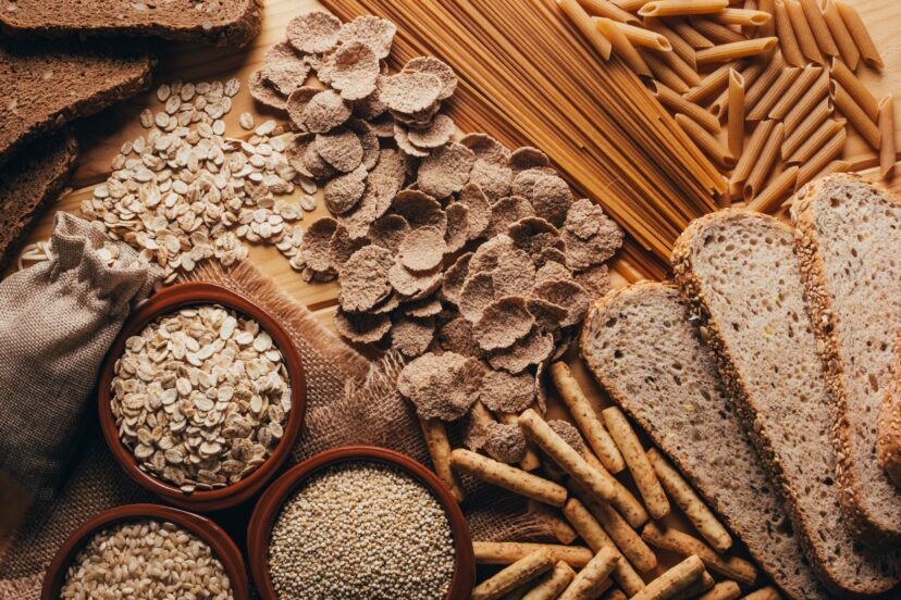 Wooden table full of fiber-rich wholegrain foods, perfect for a balanced diet.
