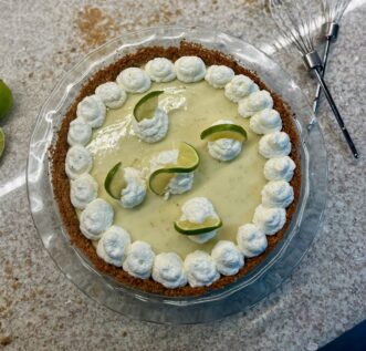 A pie with whipped cream icing.