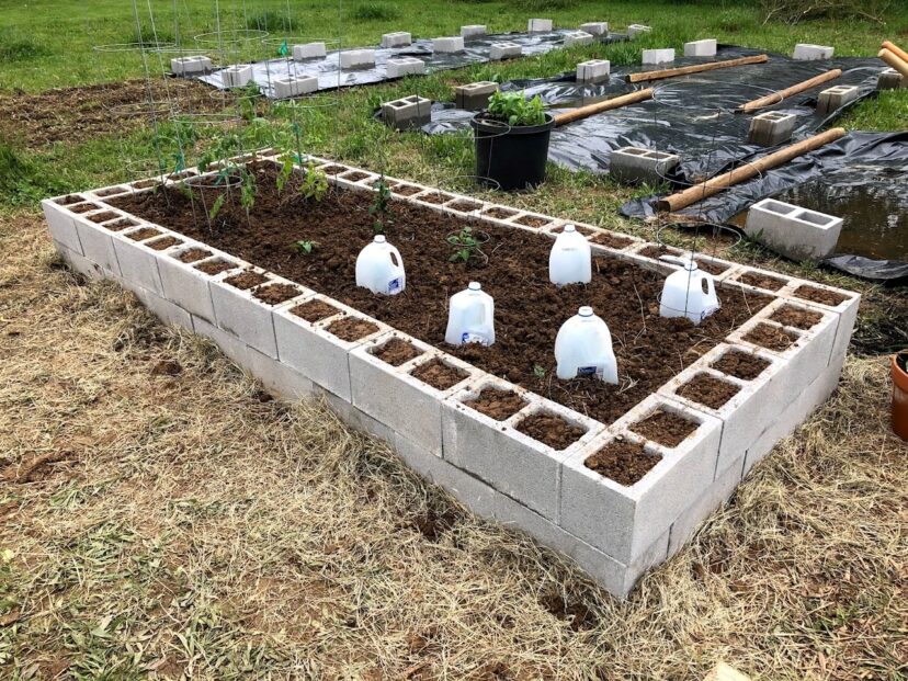 A topsoil layer is added to a raised garden bed.