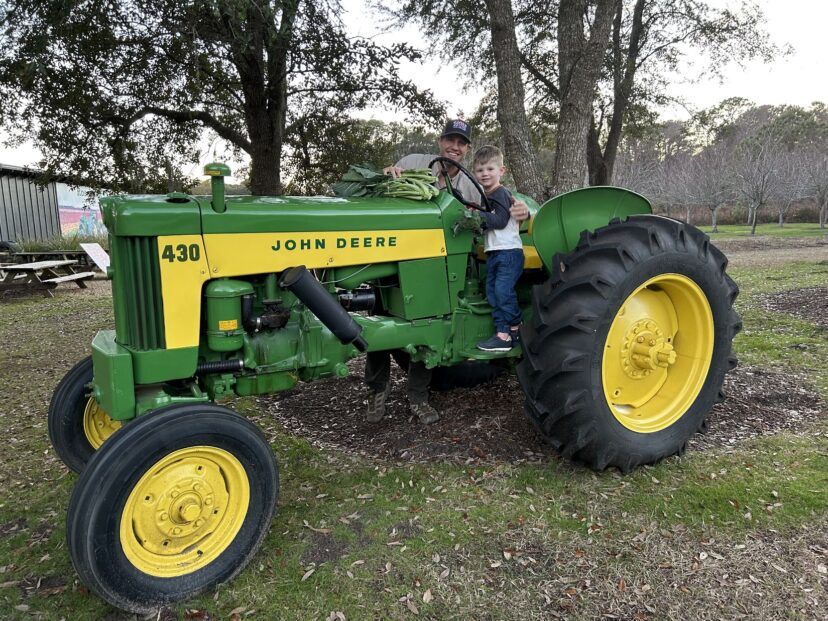 Zack with his son on a tractor at Rosebank Farms.