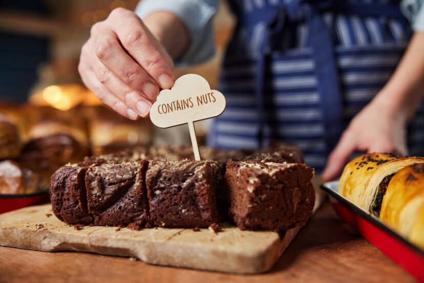 A person putting a sign on a brownie AI-generated content may be incorrect.