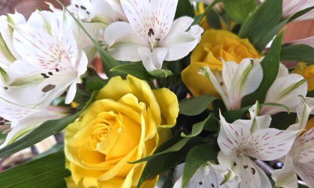 Bouquet of yellow roses and Peruvian lilies symbolizing friendship, mutual support, joy, and devotion in the language of flowers.
