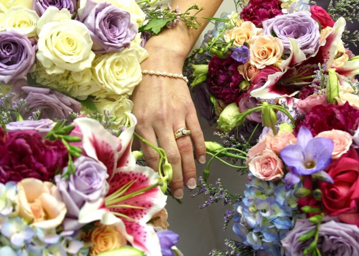 “Bridesmaids holding coordinated bouquets that echo the bride’s arrangement, matching the wedding’s color palette and overall style.”