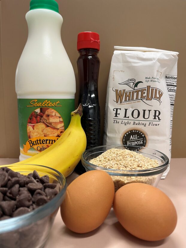 Ingredients used to make banana chocolate chip pancakes arranged on a countertop