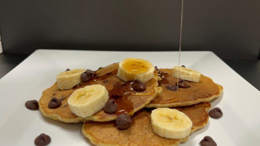 Stack of chocolate chip banana pancakes served on a plate for breakfast