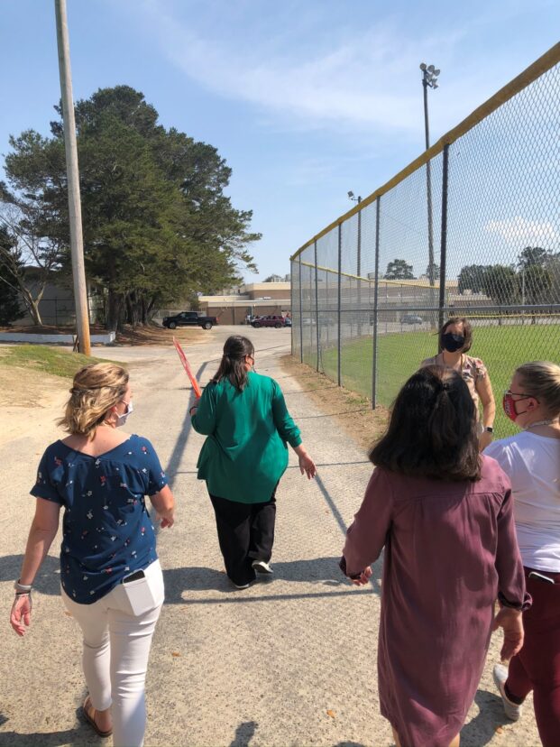 People walking together outdoors to build social connections and improve health.