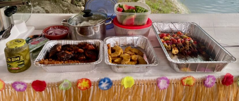 Food outdoors at a summer cookout on a festive table.