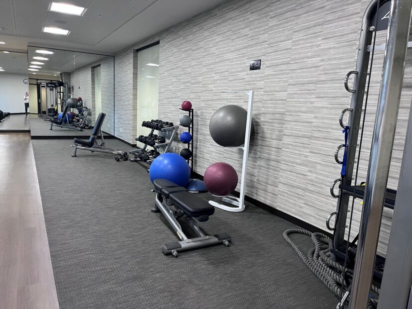 Photograph of a modern gym interior featuring workout equipment.